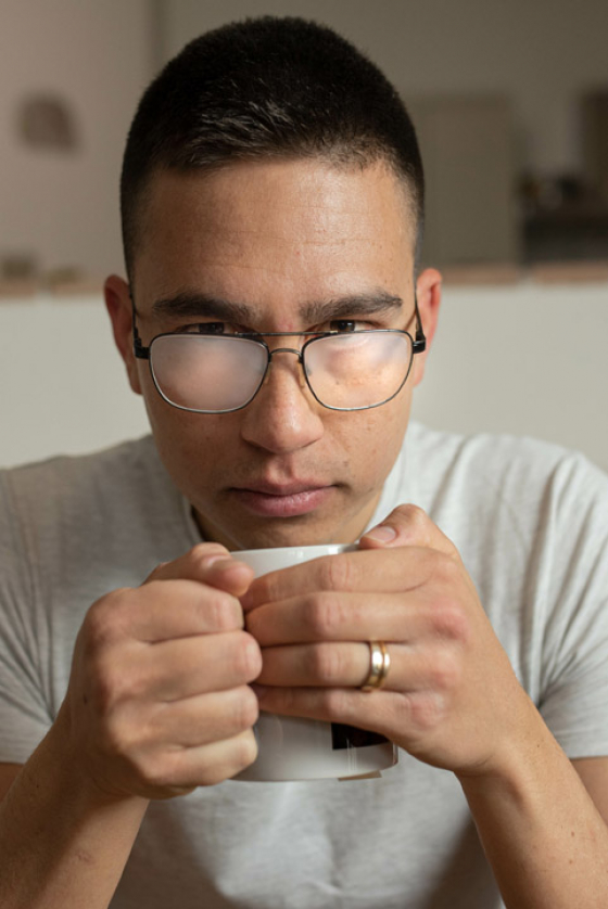 Person drinking tea with steamed up glasses