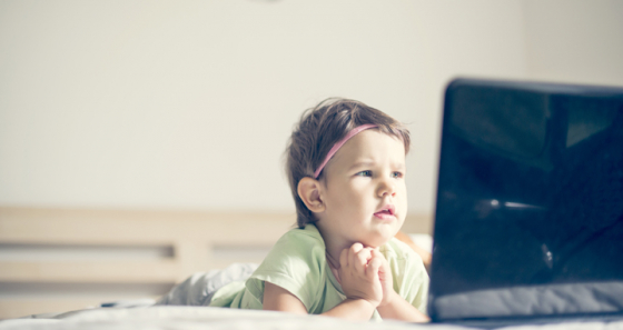 Little girl close to screen to see it clearly